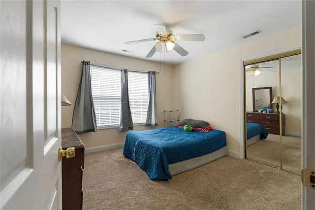 a living room with a bed and a chandelier