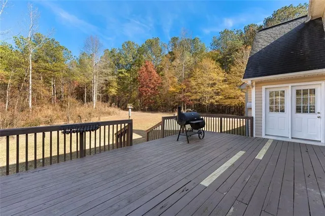 a view of a chairs on deck with wooden floor and fence
