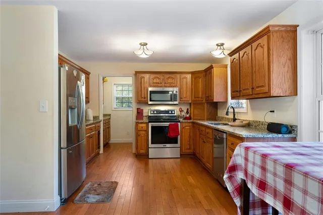 a kitchen with a stove a sink and a refrigerator