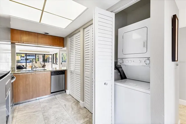 a view of a patio with a table and chairs and potted plants