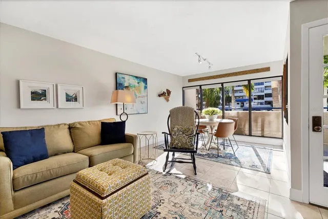 a living room with furniture and a kitchen view