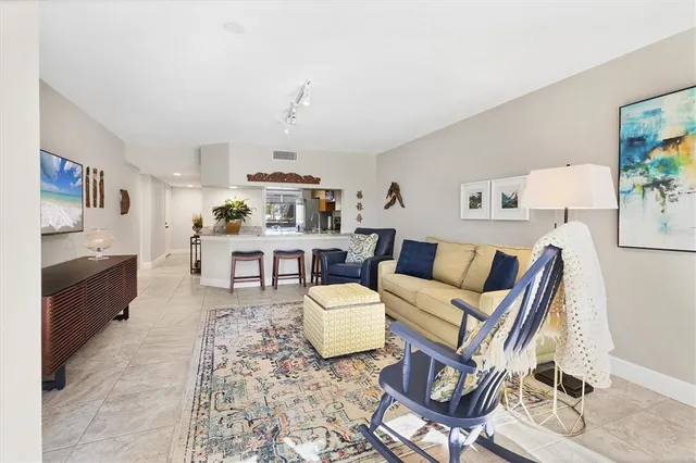 a living room with furniture a rug and white walls
