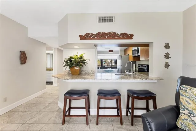 a view of a kitchen with a refrigerator and a window