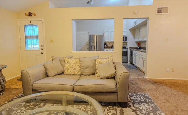 a living room with a couch and a stove top oven