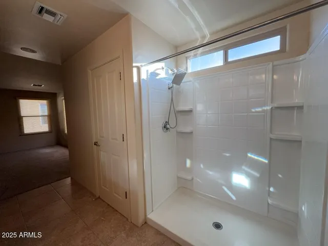 a bathroom with a glass shower door