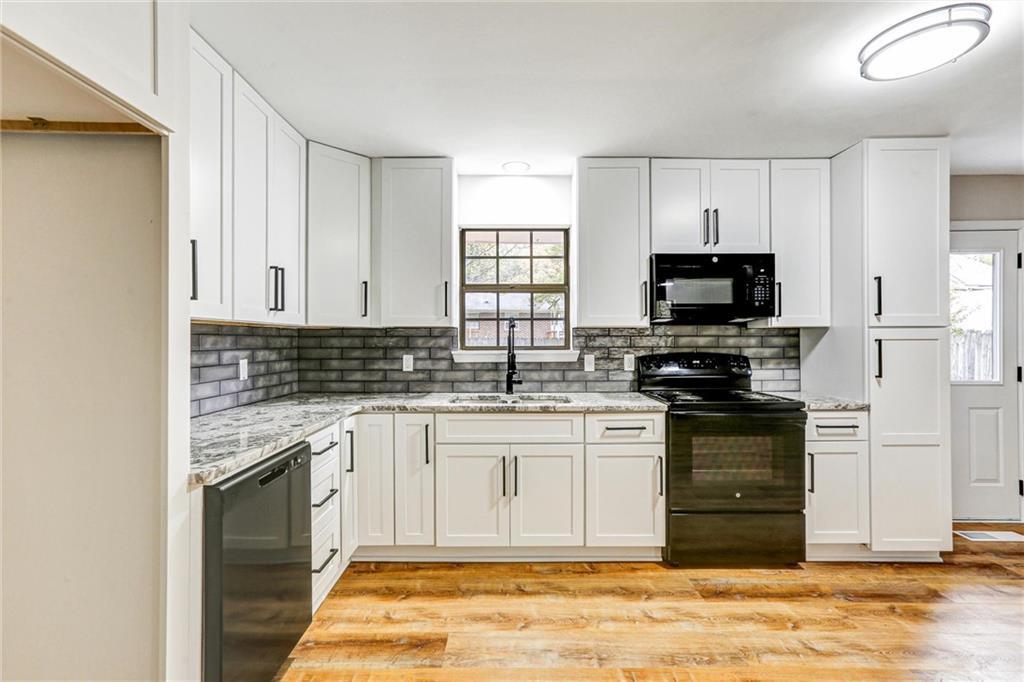 122 Capitol Avenue Winder, GA 30680 - Photo 11 of 34 a kitchen with stainless steel appliances granite countertop a stove a sink and a microwave