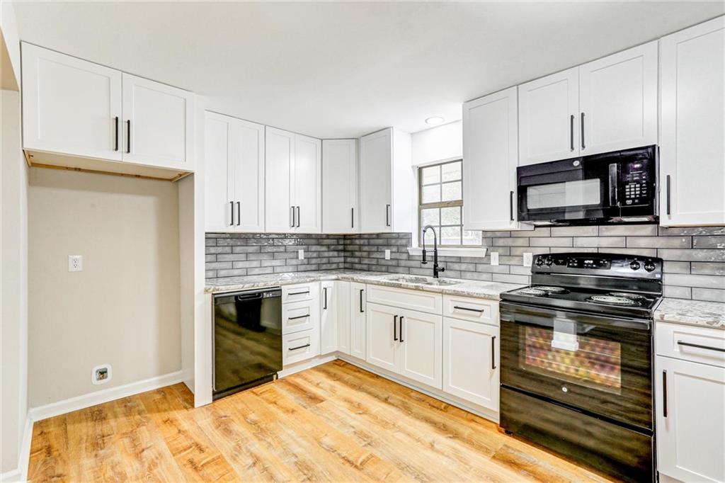 122 Capitol Avenue Winder, GA 30680 - Photo 12 of 34 a kitchen with a stove and a microwave