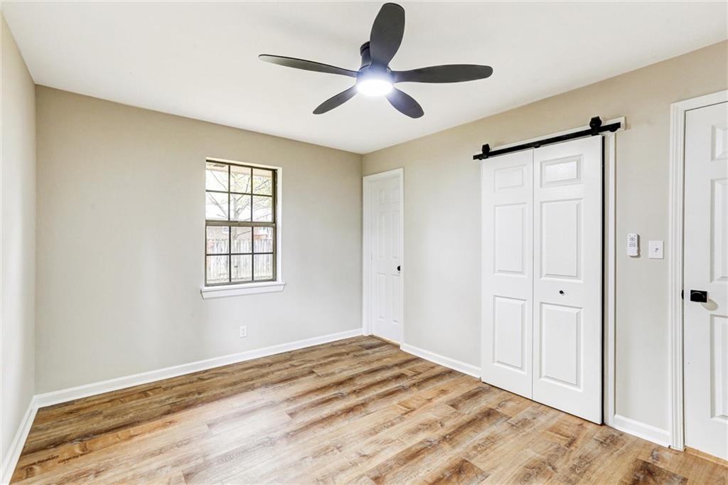 122 Capitol Avenue Winder, GA 30680 - Photo 15 of 34 a view of empty room with wooden floor and fan