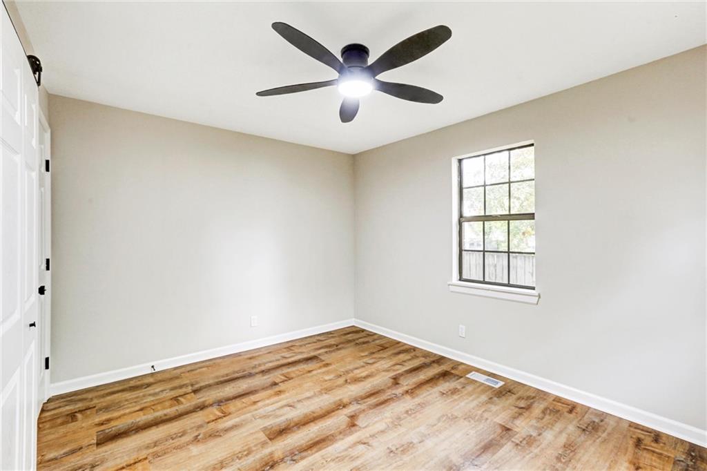122 Capitol Avenue Winder, GA 30680 - Photo 16 of 34 wooden floor in an empty room with a window