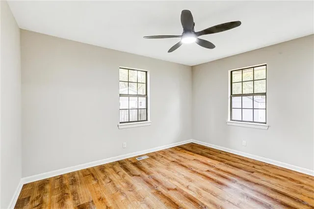 a view of a livingroom with a ceiling fan and window