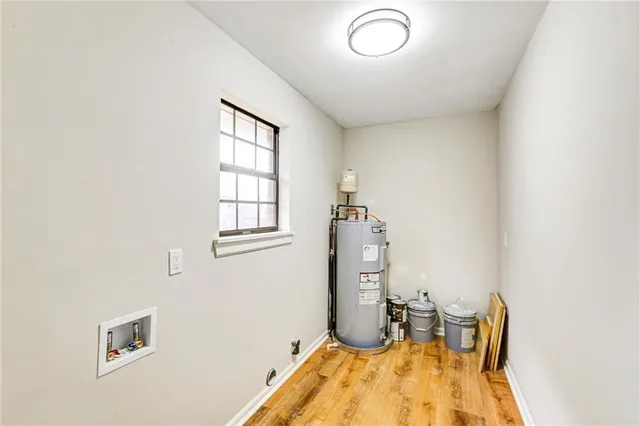 a view of a house with a big yard and large tree