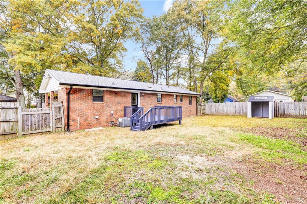 122 Capitol Avenue Winder, GA 30680 - Photo 30 of 34 a view of a house with a big yard and large tree