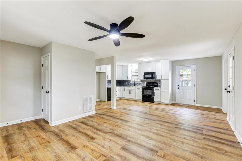 122 Capitol Avenue Winder, GA 30680 - Photo 4 of 34 a view of a kitchen with wooden floor and a window