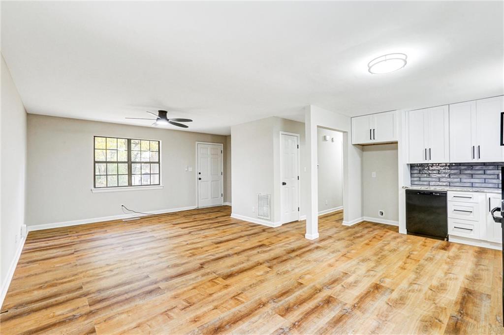 122 Capitol Avenue Winder, GA 30680 - Photo 6 of 34 a view of an empty room with a kitchen and a window