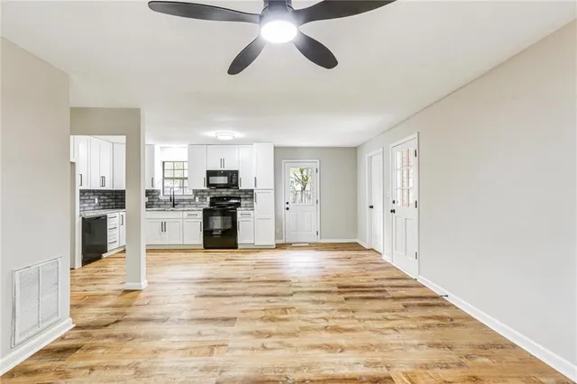 a view of kitchen with refrigerator stove microwave and cabinets