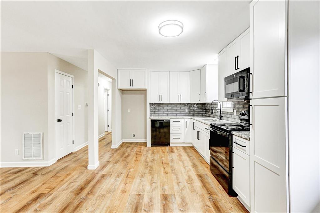 122 Capitol Avenue Winder, GA 30680 - Photo 10 of 34 a large kitchen with cabinets and stainless steel appliances