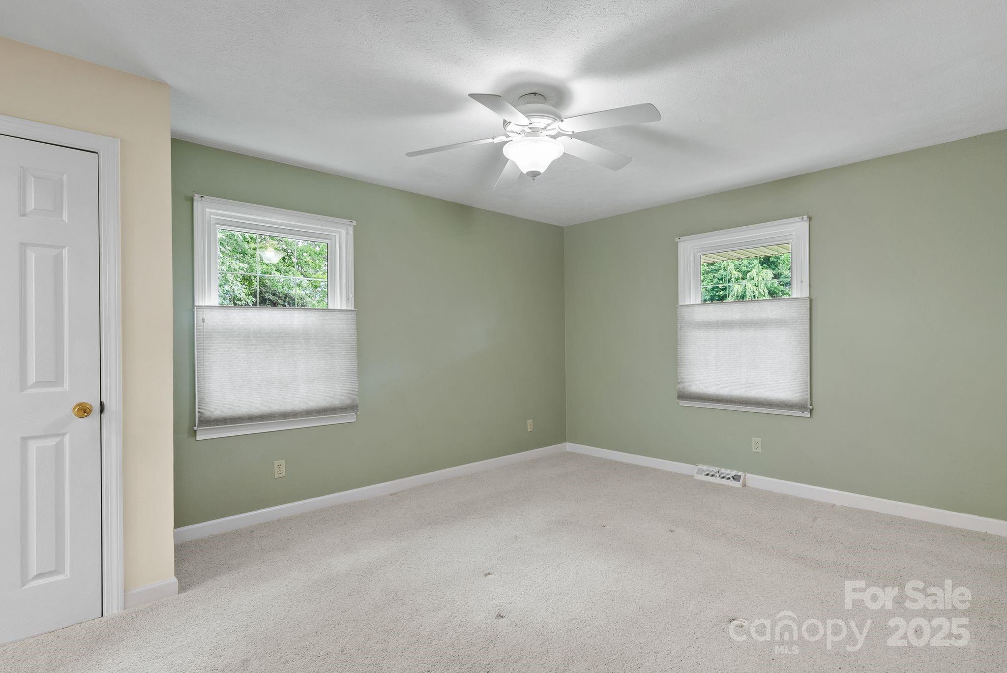 6693 Brevard Road Etowah, NC 28729 - Photo 24 of 42 a view of room with window and ceiling fan