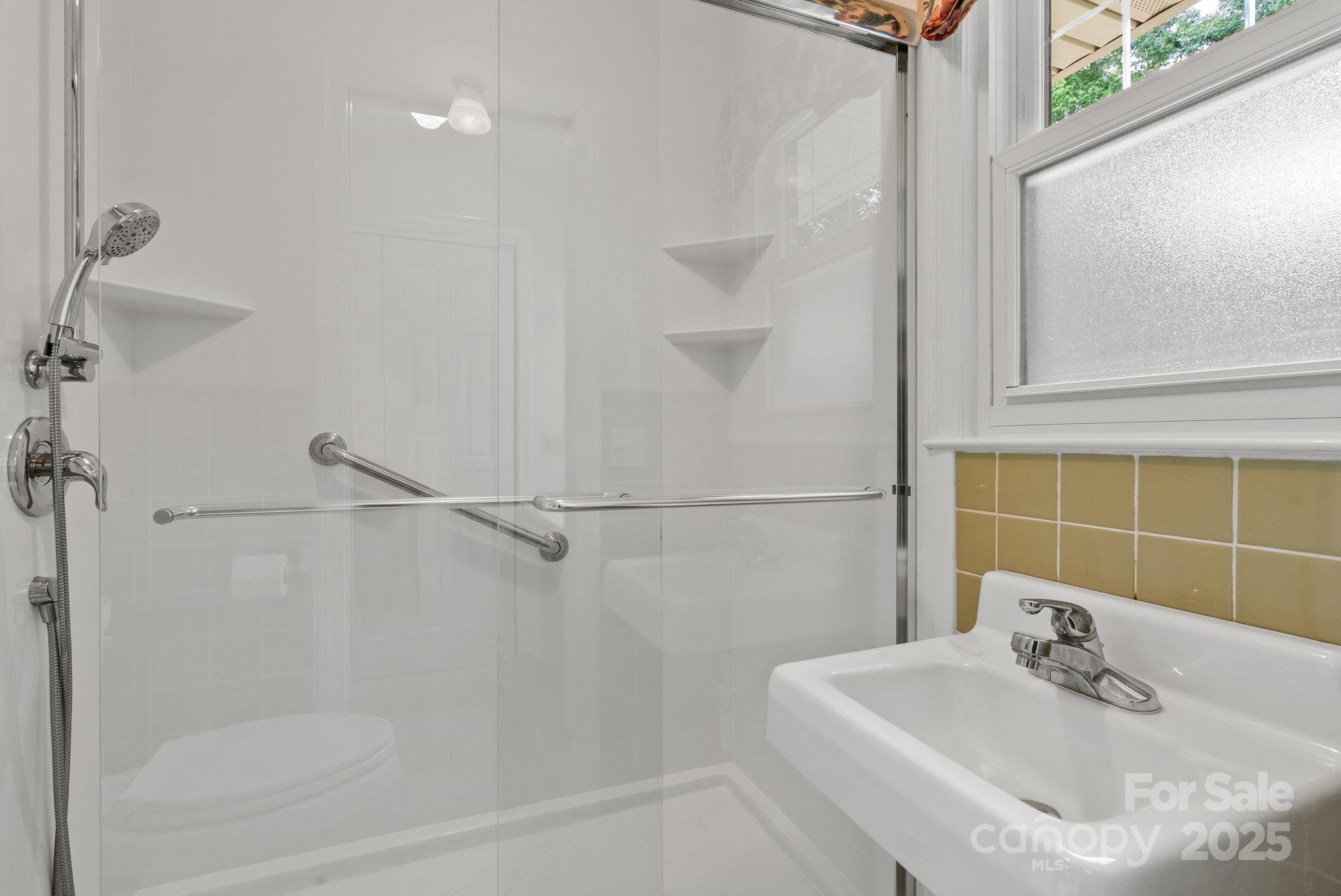 6693 Brevard Road Etowah, NC 28729 - Photo 27 of 42 a bathroom with a sink and shower