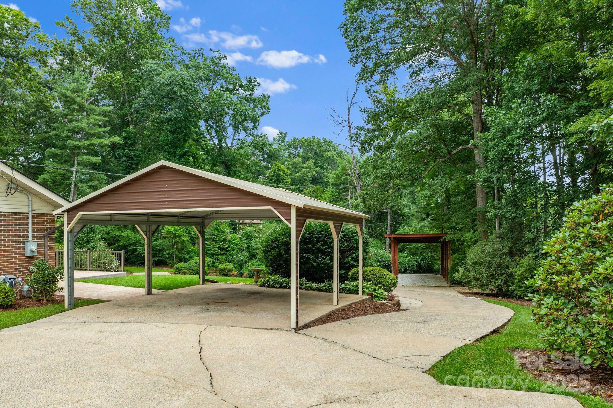 6693 Brevard Road Etowah, NC 28729 - Photo 3 of 42 a house view with a garden space