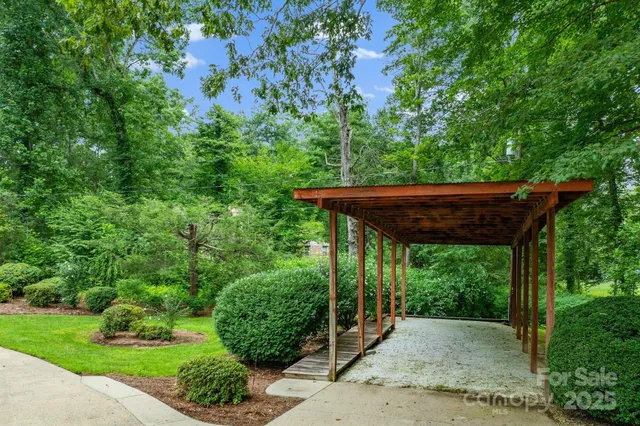 a view of a patio with a table and chairs under an umbrella