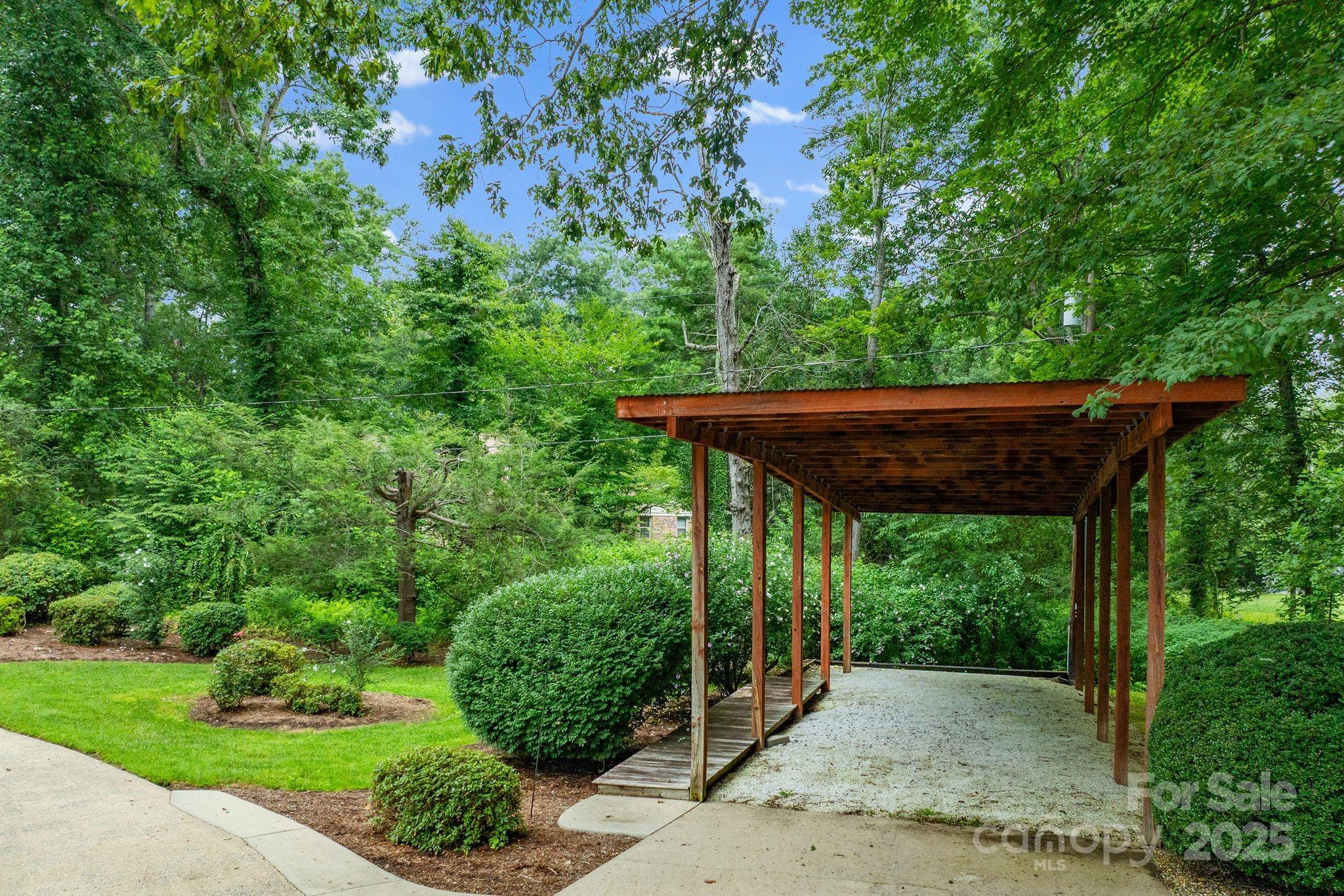 6693 Brevard Road Etowah, NC 28729 - Photo 4 of 42 a view of a patio with a table and chairs under an umbrella