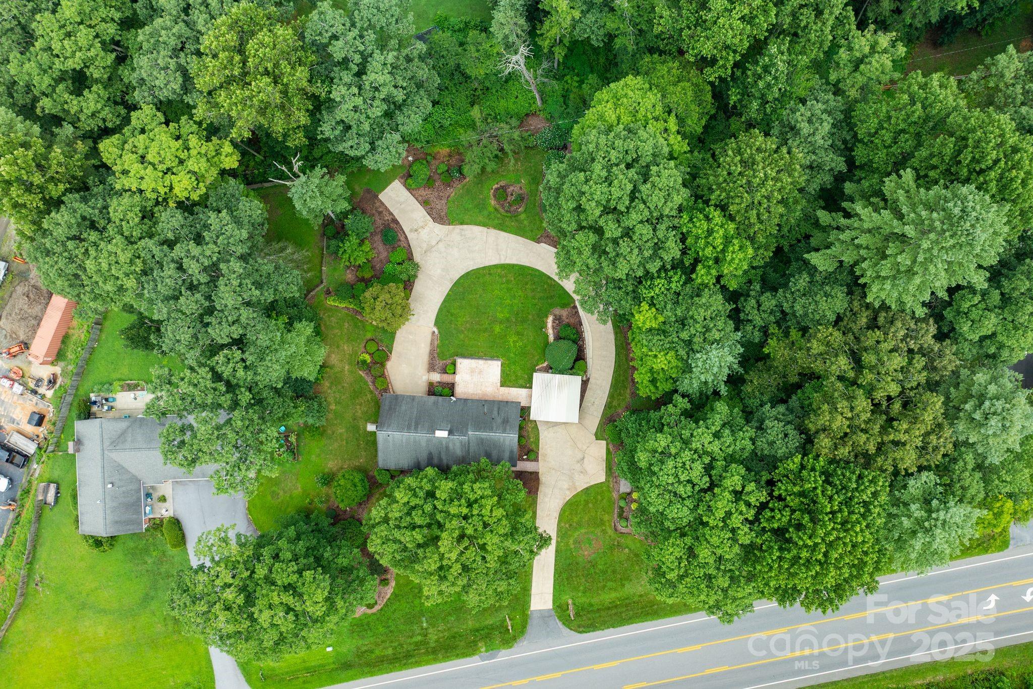 6693 Brevard Road Etowah, NC 28729 - Photo 41 of 42 a view of a garden with large trees