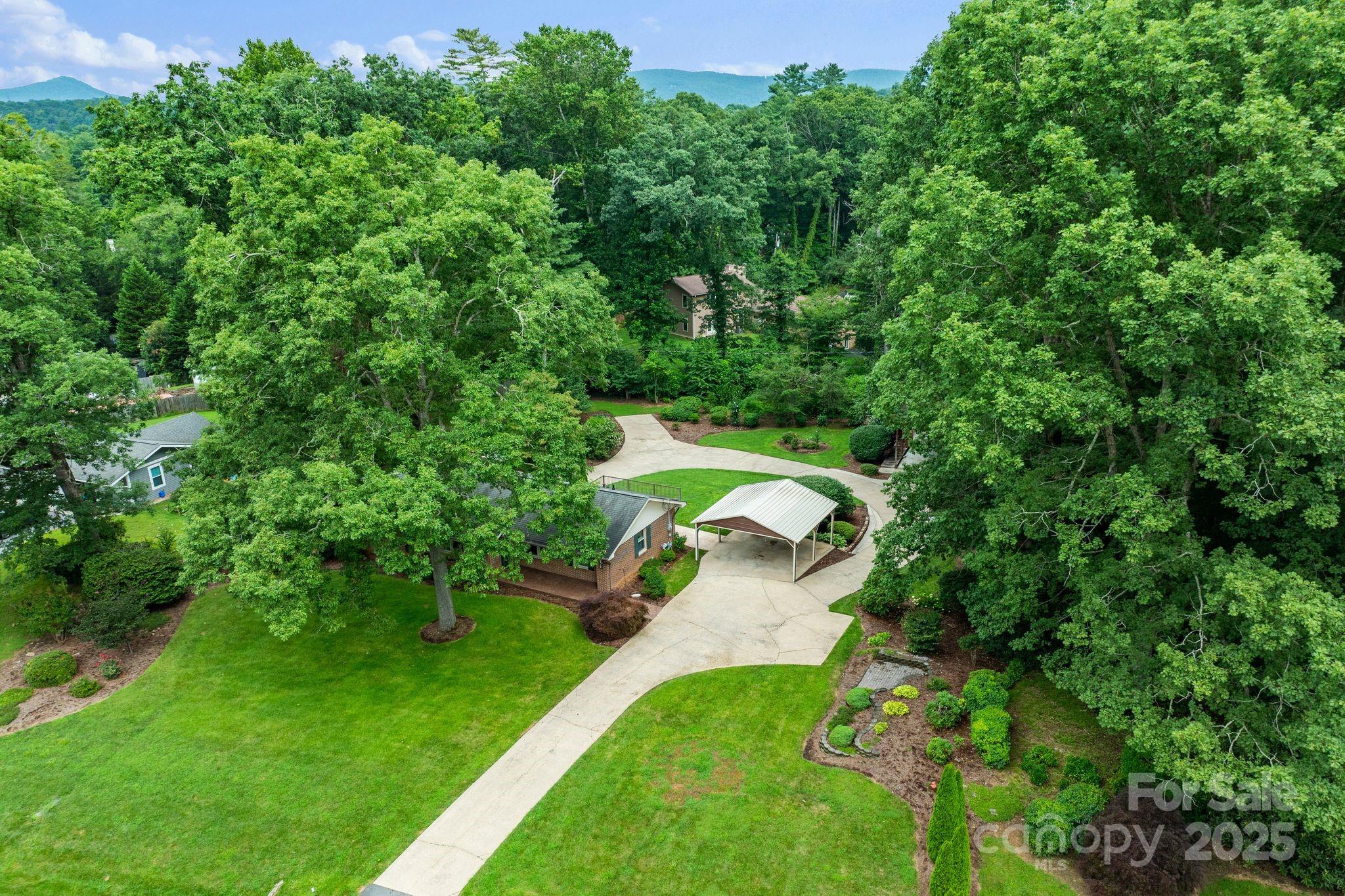 6693 Brevard Road Etowah, NC 28729 - Photo 10 of 42 an aerial view of residential house with outdoor space and trees around