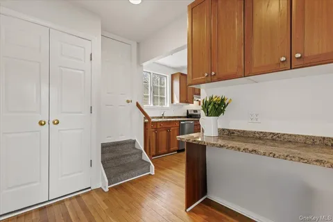 a kitchen with stainless steel appliances granite countertop a sink a stove a refrigerator and cabinets
