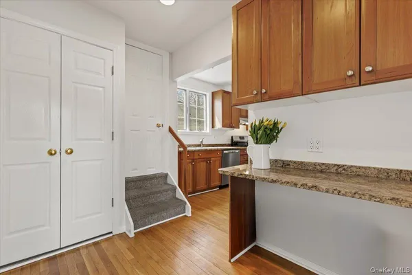 a kitchen with stainless steel appliances granite countertop a sink a stove a refrigerator and cabinets