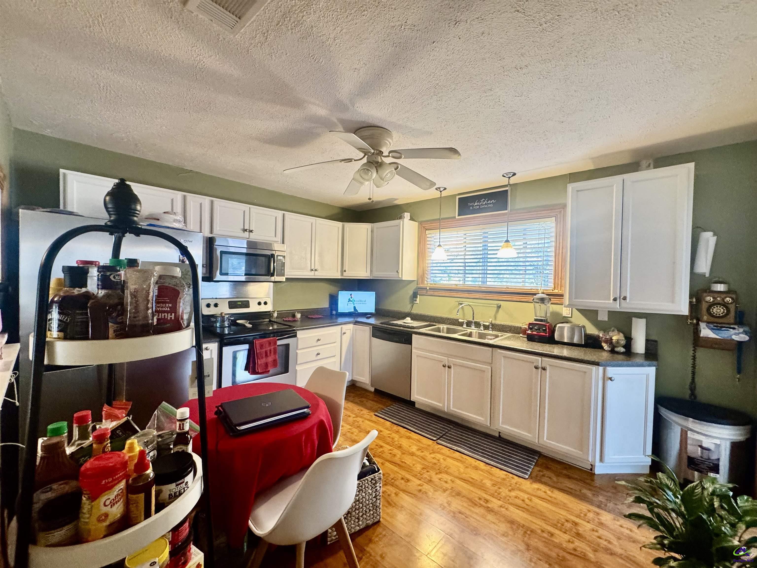914 Adderton Street Americus, GA 31719 - Photo 35 of 53 a kitchen with stainless steel appliances granite countertop a stove and a sink