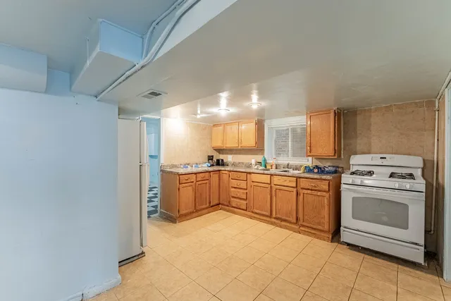 a large kitchen with a stove and a refrigerator