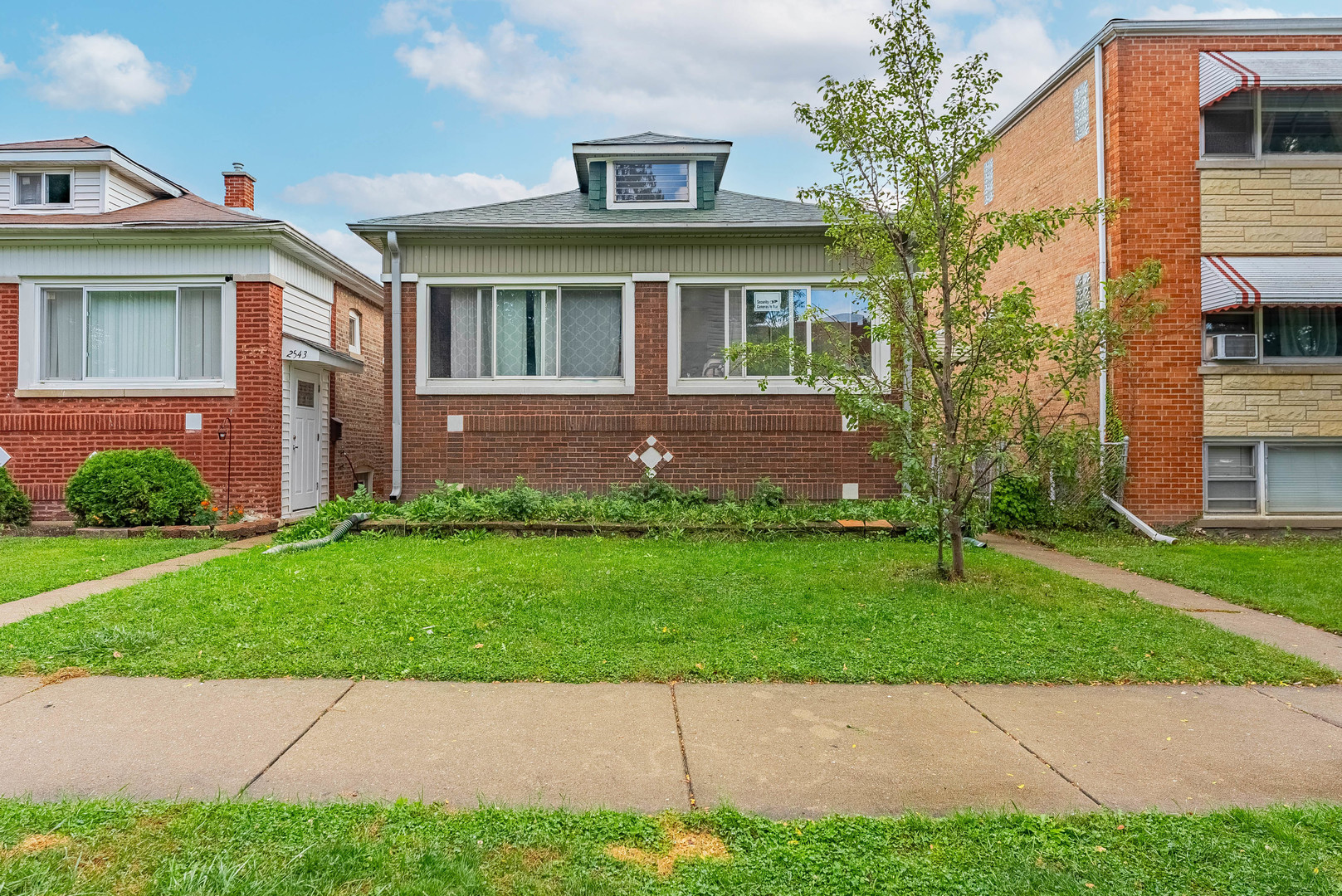 2541 North Mont Clare Avenue Chicago, IL 60707 - Photo 2 of 31 a front view of a house with a garden