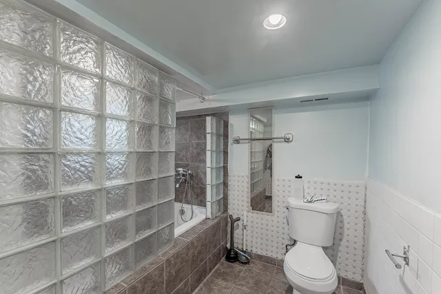 a view of a closet area with wooden floor