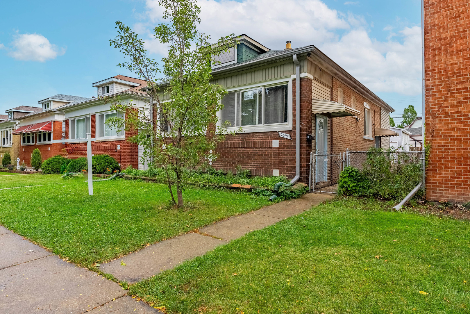 2541 North Mont Clare Avenue Chicago, IL 60707 - Photo 3 of 31 a front view of house with yard and green space