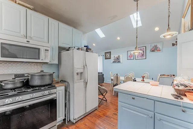 a kitchen with a sink a stove and refrigerator