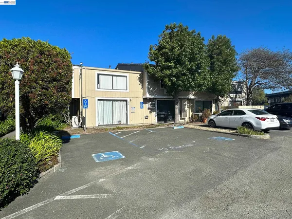 a view of a street with a car parked in front of it