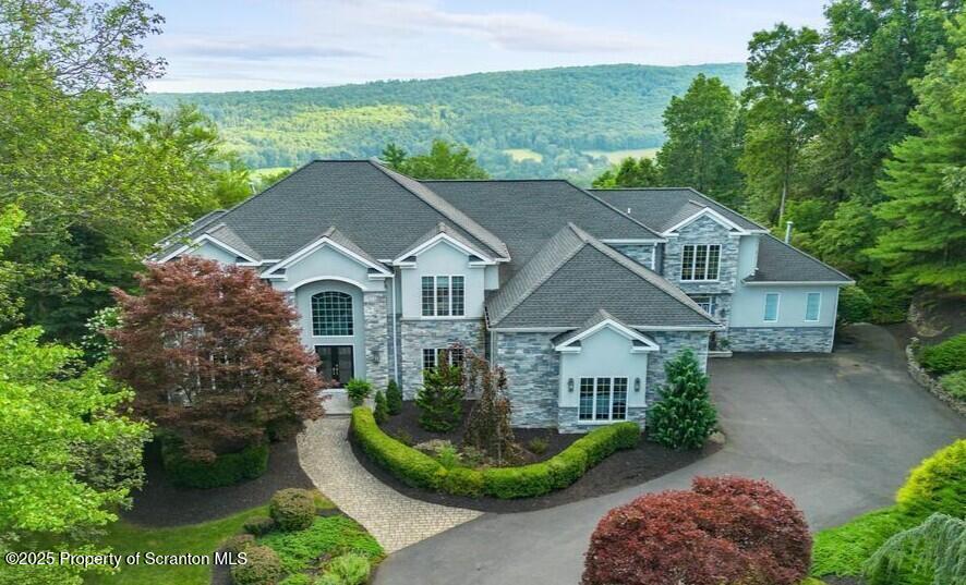 a aerial view of a house next to a yard