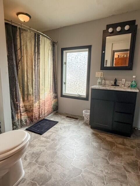 805 Sunset Drive Kouts, IN 46347 - Photo 9 of 17 a bathroom with a toilet sink and mirror