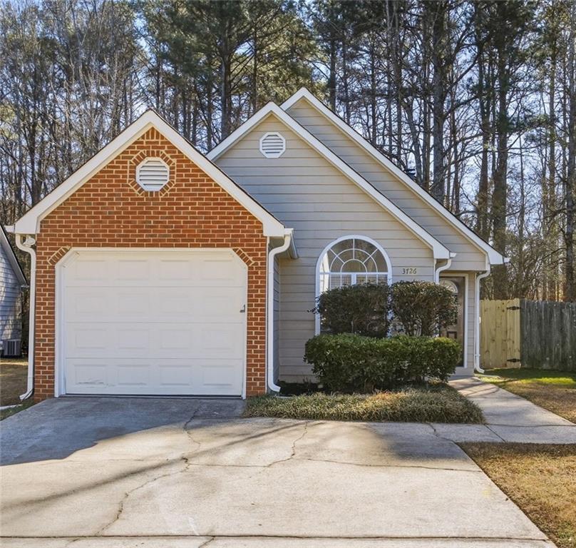 a view of a house with yard and garage
