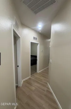 a view of hallway with wooden floor