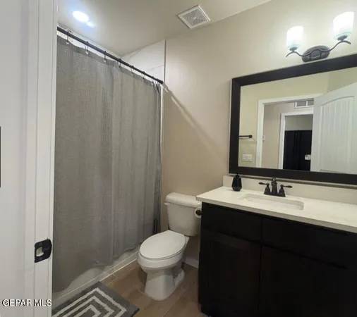 a bathroom with a toilet a sink and a mirror