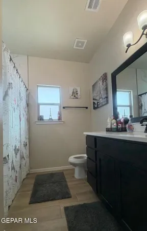 a bathroom with a toilet sink and mirror
