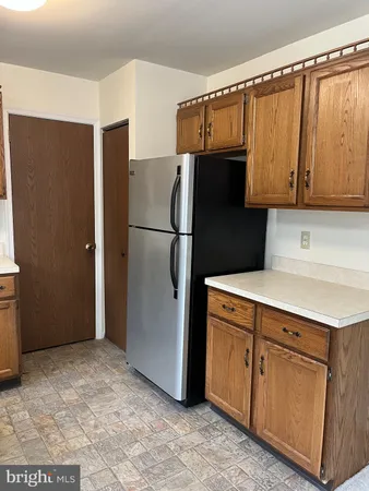 a kitchen with a refrigerator and a cabinets
