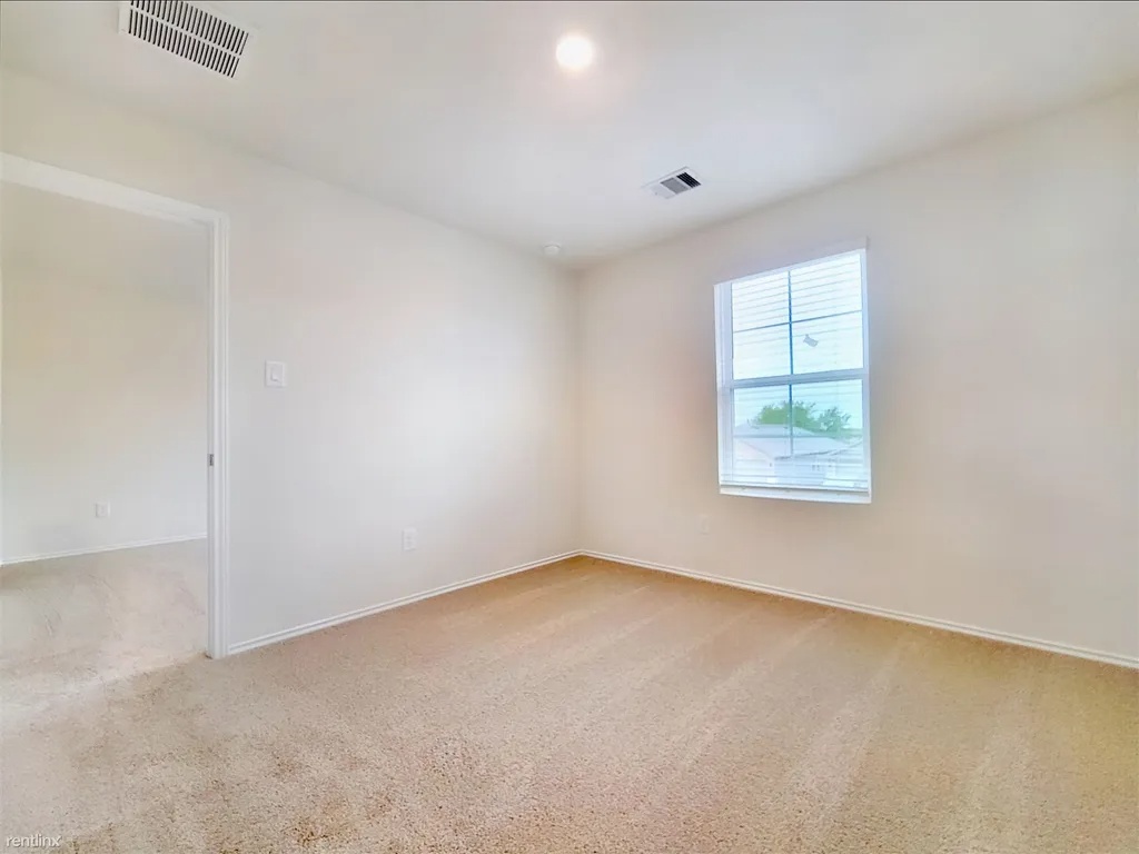 419 Sickle Loop Kyle, TX 78640 - Photo 22 of 35 A window-filled room with plush carpeting offers a neutral canvas for your personal style.