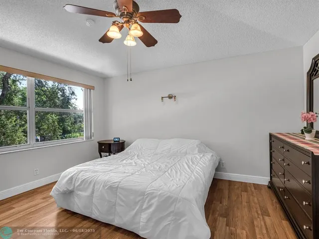 a bedroom with a bed and a potted plant