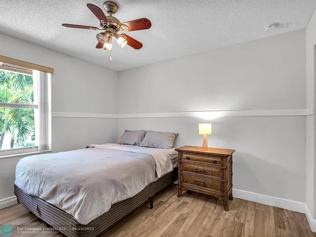 a bedroom with a bed and a ceiling fan