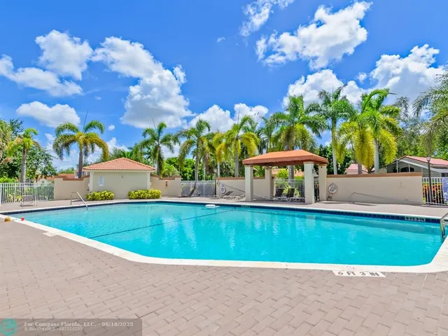 a view of a swimming pool with a yard