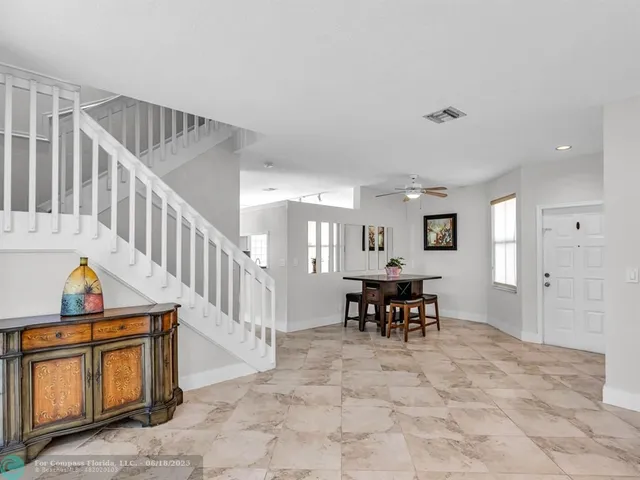a view of a livingroom with furniture & furniture windows