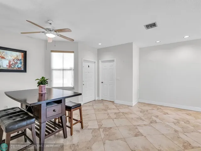 a view of a workspace with furniture and window