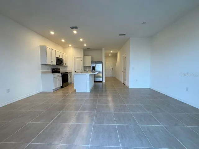 a view of a kitchen with a sink and cabinets
